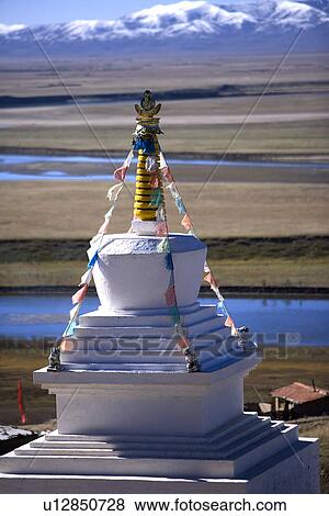 Stock Photo - China, Sichuan, First Bay Of The Winding Yellow River, White tower with prayer flag. Fotosearch