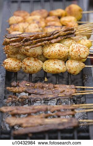 China, Sichuan Province, Barbecue grill with yak beefs and potatoes View Large Photo Image Picture - China, Sichuan Province, Barbecue grill with yak beefs and potatoes. Fotosearch