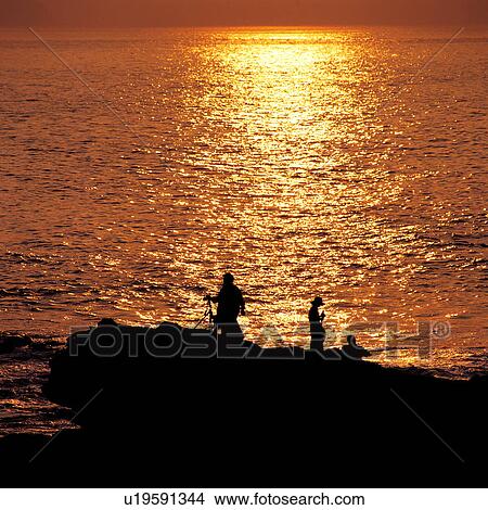 Three persons taking photograph of sea View Large Photo Image Picture - Three persons taking photograph of sea. Fotosearch
