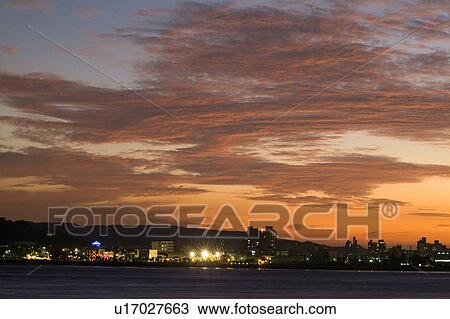 Stock Image - Taiwan, Bali, Cityscape under pink clouds. Fotosearch