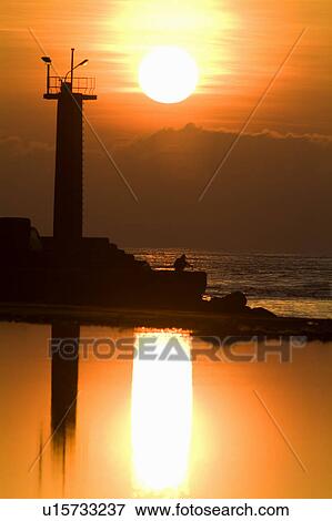 Stock Photo - Taiwan, lighthouse at sunset. Fotosearch