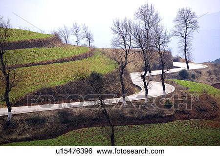 Stock Photograph - China, Yunnan Province, Dongchuan, Red Land, winding road. Fotosearch