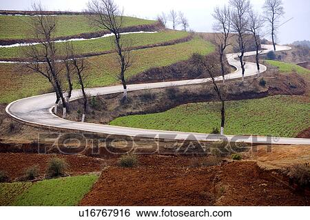 Stock Photograph - China, Yunnan Province, Dongchuan, Red Land, winding road. Fotosearch