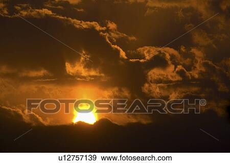 Stock Photo - China, Yunnan Province, Dongchuan, sun and clouds. Fotosearch