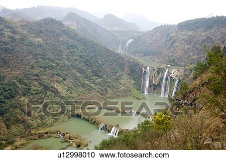 Stock Image - China, Yunnan Province, Luoping County, Nine-dragon Waterfall. Fotosearch