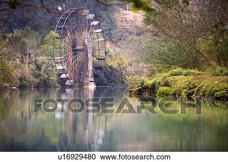 Stock Image - China, Yunnan Province, Luoping County, ancient water wheel. Fotosearch