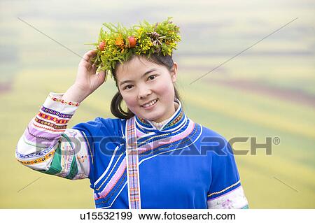 China, Yunnan Province, Luoping County, Buyi National Minority, Young woman in flower headdress wearing traditional clothing View Large Photo Image Stock Photo - China, Yunnan Province, Luoping County, Buyi National Minority, Young woman in flower headdress wearing traditional clothing. Fotosearch