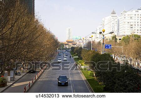 Stock Image - China, Yunnan Province, Kunming, Golden Horse And Jade Rooster Archway, Street view. Fotosearch