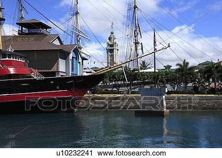 Stock Image - "Boat And Aloha Tower, Honolulu, Hawaii, U. S. A. ". Fotosearch
