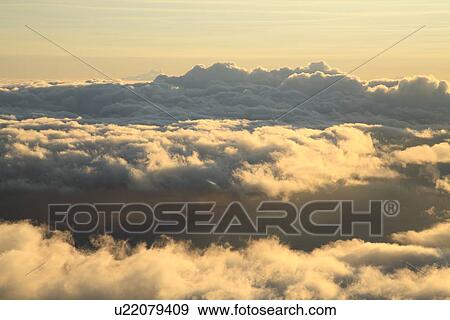 Stock Photo - "Morning Glow And Field Of Clouds, Maui, Hawaii, U. S. A. ". Fotosearch