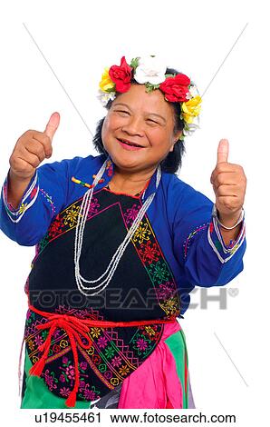 Stock Image - Female Aboriginal dancer showing thumbs up sign and smiling, Taiwan. Fotosearch