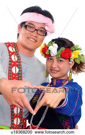 Stock Image - Portrait of a Taiwanese couple gesturing and smiling, Taiwan. Fotosearch