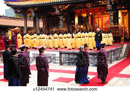 Stock Image - People praying in a temple, Taipei Confucius Temple, Taipei, Taiwan. Fotosearch