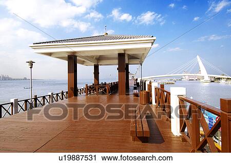 Stock Image - Pier with bridge in the background, Lovers Bridge, Danshui, Taipei, Taiwan. Fotosearch