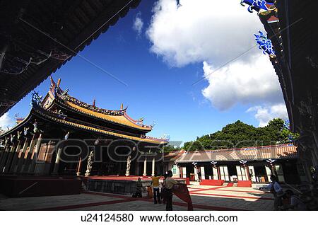 Stock Image - Tourists in a temple, Taipei Confucius Temple, Taipei, Taiwan. Fotosearch