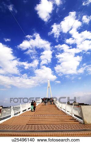 Stock Image - Tourists walking on a bridge, Lovers Bridge, Danshui, Taipei, Taiwan. Fotosearch