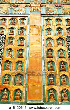Stock Photograph - Statue of Buddha carved on a pagoda wall, Summer Palace, Beijing, China. Fotosearch