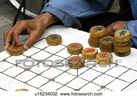 Man playing Chinese chess, Beijing, China View Large Photo Image Stock Image - Man playing Chinese chess, Beijing, China. Fotosearch