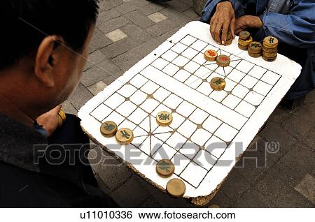 Stock Photograph - Men playing Chinese chess, Beijing, China. Fotosearch