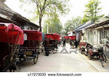 Stock Image - Rickshaws on the road, Beijing, China. Fotosearch
