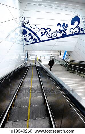 Stock Image - Passenger on escalators in a subway station, Beijing, China. Fotosearch