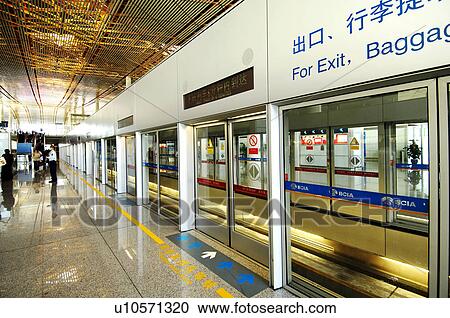 Stock Image - Passengers in an airport, Beijing Capital International Airport, Beijing, China. Fotosearch