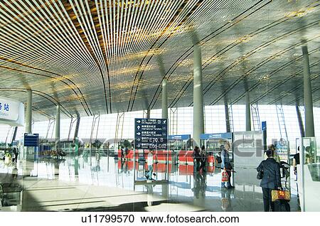 Stock Image - Passengers in an airport, Beijing Capital International Airport, Beijing, China. Fotosearch