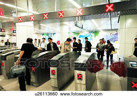 Stock Image - Passengers on afc gates in a subway station, Beijing, China. Fotosearch
