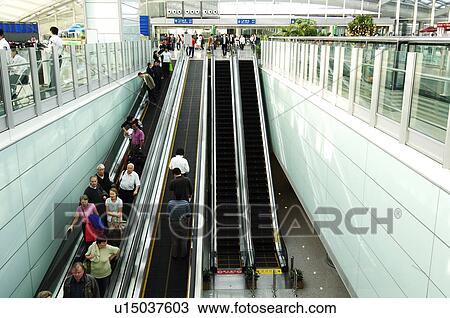 Stock Image - Passengers on escalators in a subway station, Beijing, China. Fotosearch