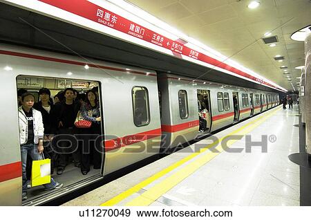 Stock Photo - Passengers traveling in a subway train, Beijing, China. Fotosearch