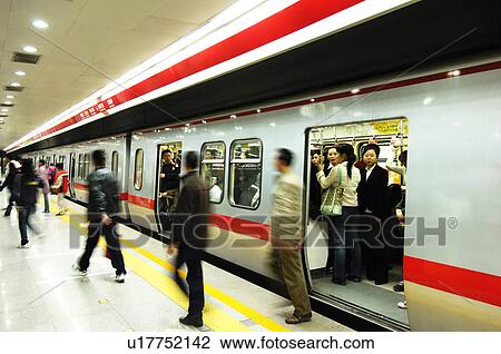 Passengers walking out of subway train, Beijing, China View Large Photo Image Stock Image - Passengers walking out of subway train, Beijing, China. Fotosearch
