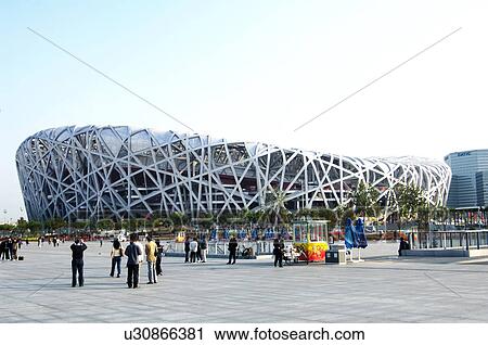 Stock Image - People walking near the olympic stadium, Beijing National Stadium, Beijing, China. Fotosearch