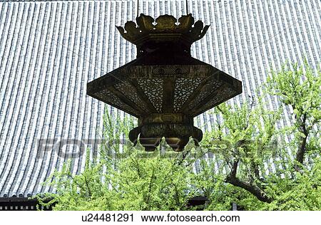 Stock Image - Garden Lantern and tiled roof. Fotosearch
