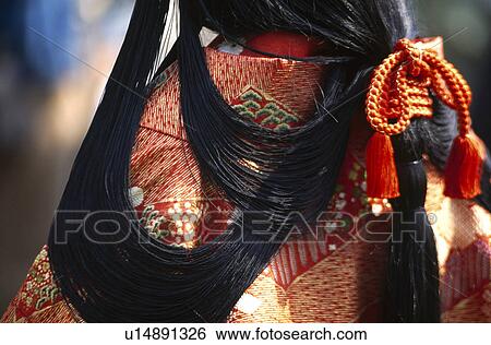 Stock Photograph - Rear view of woman in Japanese traditional wear. Fotosearch
