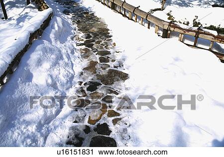 Stock Image - Stone path with snow. Fotosearch