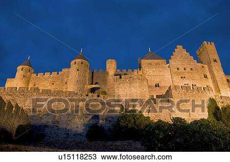 Stock Image - France, Languedoc, Carcassonne, Castle walls illuminated at night. Fotosearch