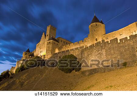 Stock Photo - France, Languedoc, Carcassonne, Castle walls illuminated at night. Fotosearch