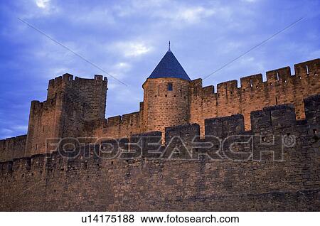 Stock Photo - France, Languedoc, Carcassonne, Castle walls illuminated at night. Fotosearch
