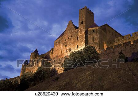 Stock Photo - France, Languedoc, Carcassonne, Castle walls illuminated at night. Fotosearch