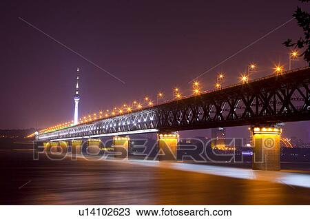 Stock Image - China, Hubei Province, Wuhan, Wuchang, Wuhan Yangtze River Bridge, Nightlife. Fotosearch