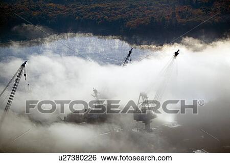 Aerial view of fog over Bath Iron Works and Kennebec River in Maine. Bath Iron Works is a leader in surface combatant design and construction with a $27 million dollar contract from the Navy for maintenance, repair and upgrades to Aegis destroyers. View Large Photo Image Stock Photograph - Aerial view of fog over Bath Iron Works and Kennebec River in Maine. Bath Iron Works is a leader in surface combatant design and construction with a $27 million dollar contract from the Navy for maintenance, repair and upgrades to Aegis destroyers.. Fotosearch