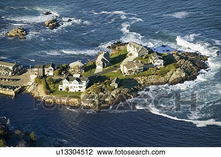 Stock Image - Aerial view of ocean-front homes on Perkins Cove, on coast of Maine south of Portland. Fotosearch