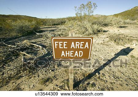Stock Photo - Fee Area" sign of Three Rivers National Petroglyph site, off Highway 54, New Mexico. Fotosearch