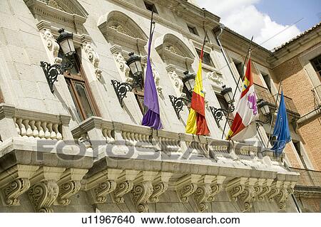 Stock Image - Flags in town center of Avila Spain, an old Castilian Spanish village. Fotosearch