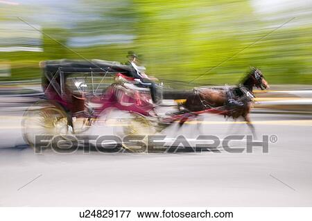 Stock Photo - Horse and carriage drives in traffic down Central Park West in Manhattan, New York City, NY. Fotosearch