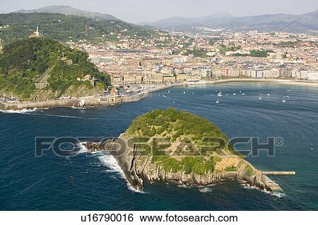 Stock Photograph - Isla Santa Clara Island in Bahia de La Concha, Donostia-San Sebastian, Basque region of Spain, the Queen of Euskadi's and Cantabrian Coast, as seen from Monte Igueldo overlook view spot. Fotosearch