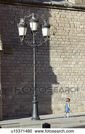 Stock Image - Little girl in Barcelona in Barri Gotic area, the Gothic Quarter, Spain. Fotosearch
