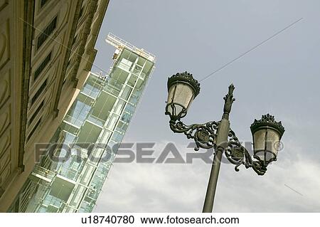 Stock Image - Looking up to a view of a street lamp and the Barcelona Museum of Contemporary Art, Barcelona, Spain. Fotosearch