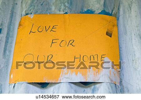 Stock Photo - Love For Our Home" sign is displayed at Pepo La Tumaini Jangwani, HIV/AIDS Community Rehabilitation Program, Orphanage & Clinic. Pepo La Tumaini Jangwani (wind of hope in the arid place) offers hope, support and care for orphan and vulnerable children li. Fotosearch