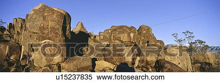 Stock Photography - Panoramic image of petroglyphs at Three Rivers Petroglyph National Site, a (BLM) Bureau of Land Management Site, features more than 21, 000 Native American Indian petroglyphs and examples of prehistoric Jornada Mogollon rock art, off Route 54, South of Car. Fotosearch